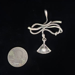 Sterling silver snake pendant by Tim Terry with coin for size reference