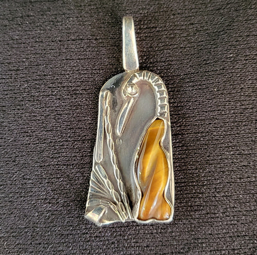 Sterling silver bird pendant with carved tiger's eye stone by Tim Terry