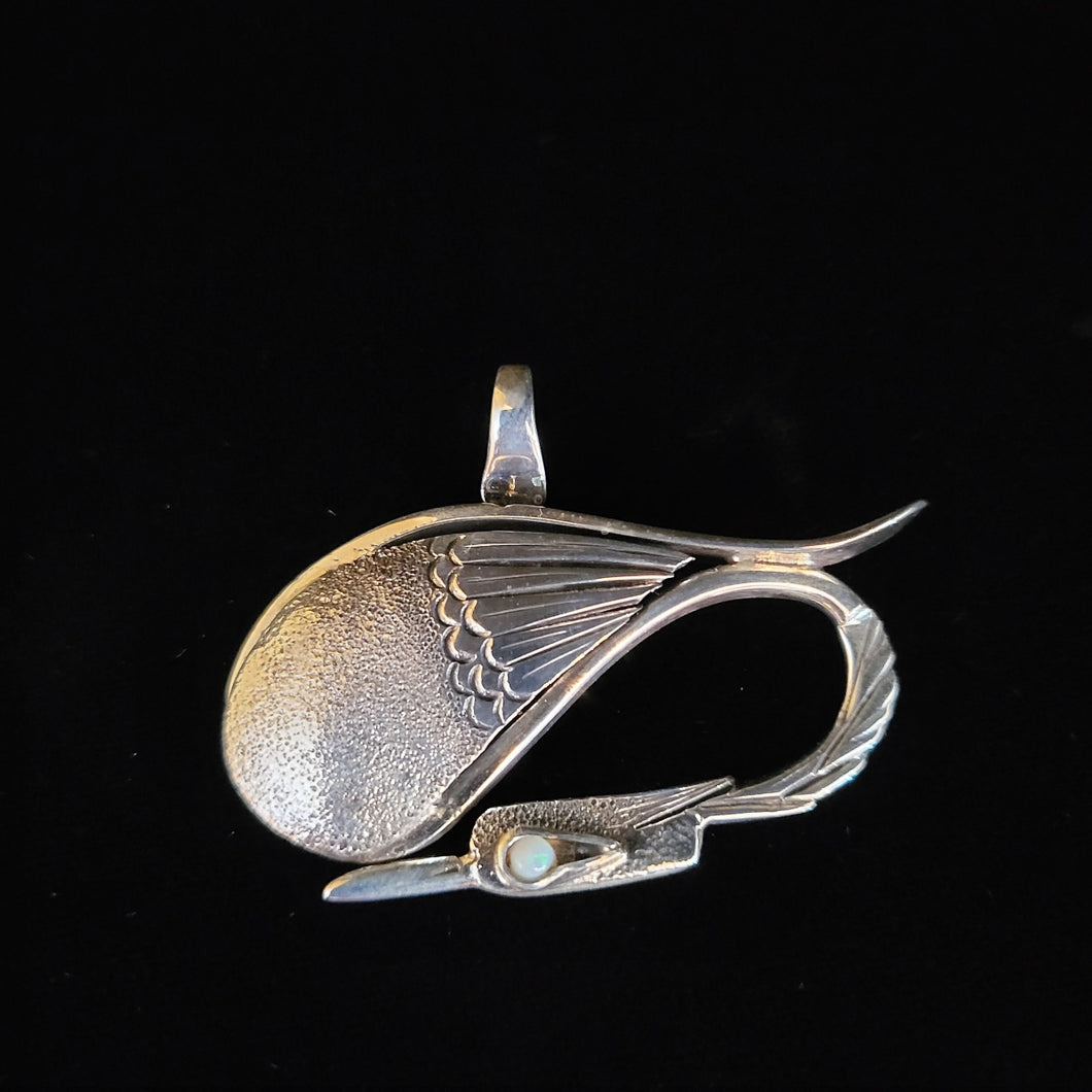 Sterling silver bird pendant with moonstone eye by artist Tim Terry