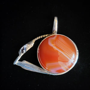 Sterling silver bird pendant with garnet eye and agate stone by artist Tim Terry