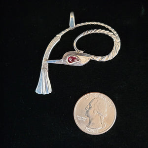Sterling silver bird pendant with garnet eye by artist Tim Terry