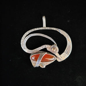 Sterling silver bird pendant with carnelian stone and gold eye by artist Tim Terry