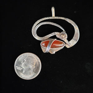 Sterling silver bird pendant with carnelian stone and gold eye by artist Tim Terry