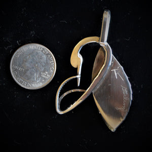 Back of pendant with coin for size reference